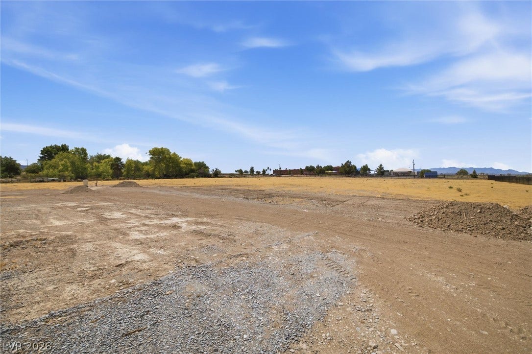 5910 E Kellogg Road, Pahrump, NV 89061 An open cleared parcel of land under expansive blue skies offers endless development potential.