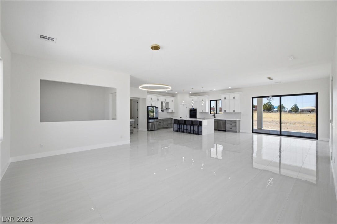 5910 E Kellogg Road, Pahrump, NV 89061 Gleaming tile floors reflect light throughout this expansive open living and kitchen area.