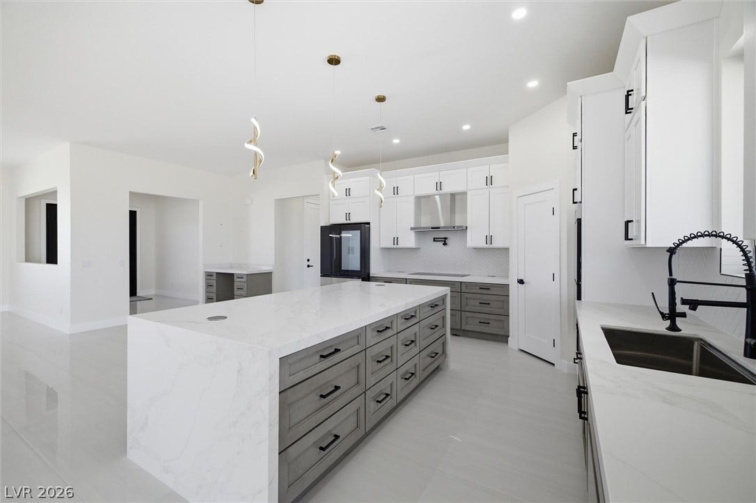 5910 E Kellogg Road, Pahrump, NV 89061 Gleaming stone countertops and a generous central island anchor this contemporary culinary space.