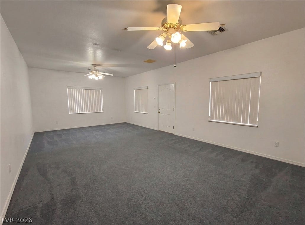 211 W Highland Drive, Henderson, NV 89015 5th room. 25x15 with door to outside and to bath. AI generated to remove storage items.