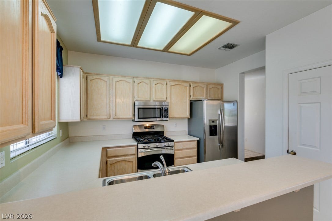 Ample counter space and classic cabinetry define this functional kitchen layout.