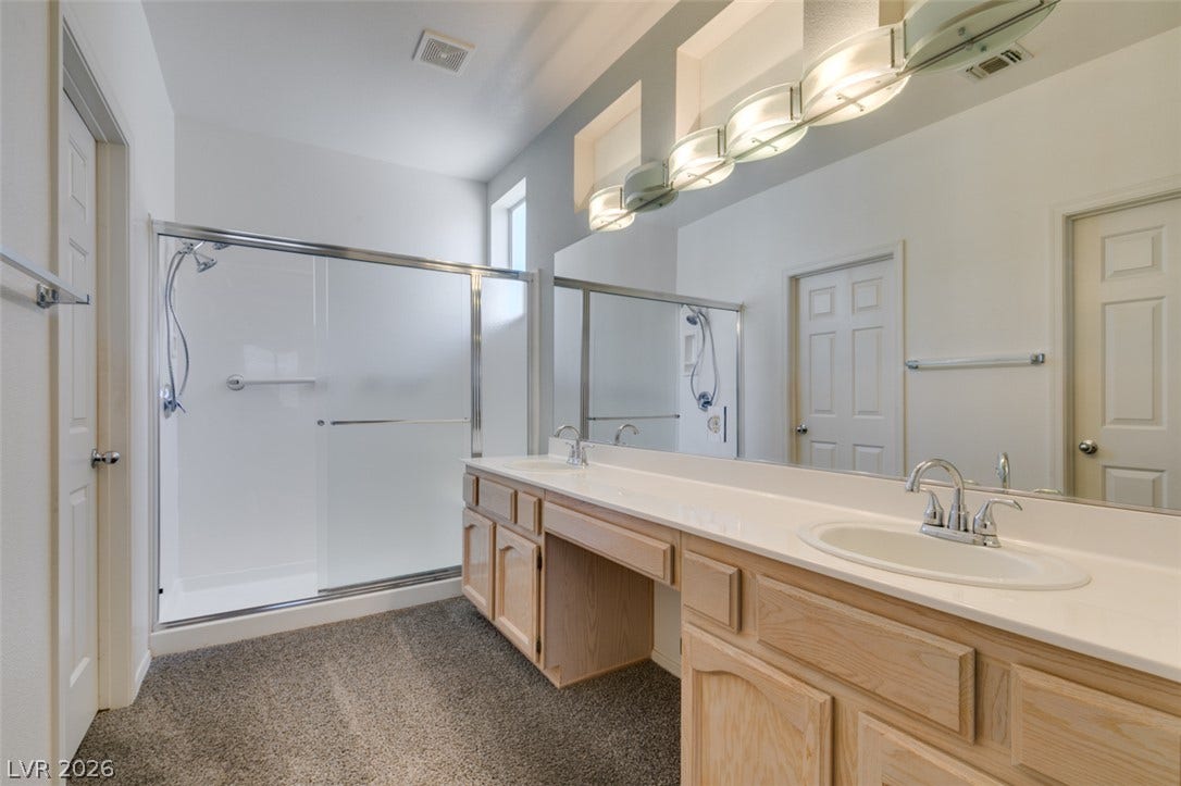 A spacious vanity with double sinks highlights this well-appointed bathroom.