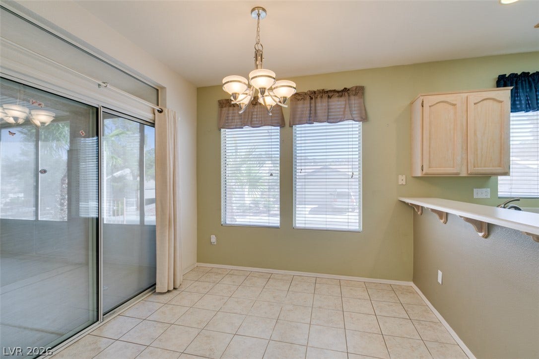 Tiled flooring and a sliding glass door define this versatile breakfast area.