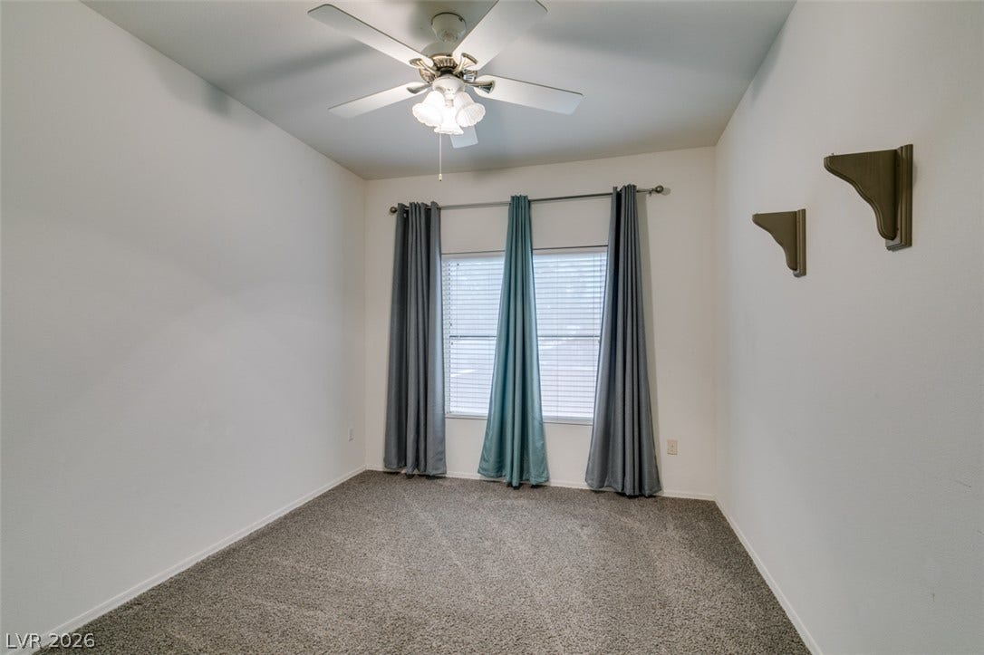 Plush carpeting and natural light define this versatile secondary bedroom space.