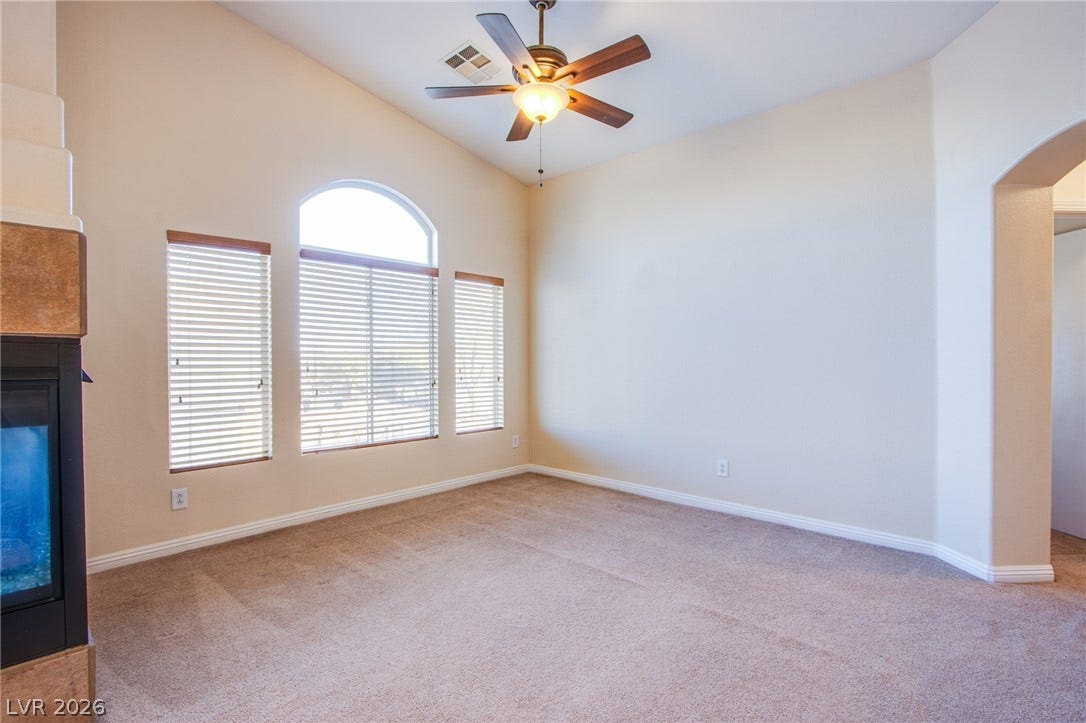 6717 Lookout Lodge Lane, #1, North Las Vegas, NV 89084 An arched window and vaulted ceilings bring character to this airy living space.