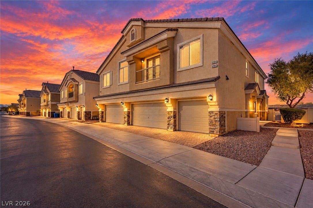 6717 Lookout Lodge Lane, #1, North Las Vegas, NV 89084 Multi-car garages and a private balcony detail this classic stucco exterior.