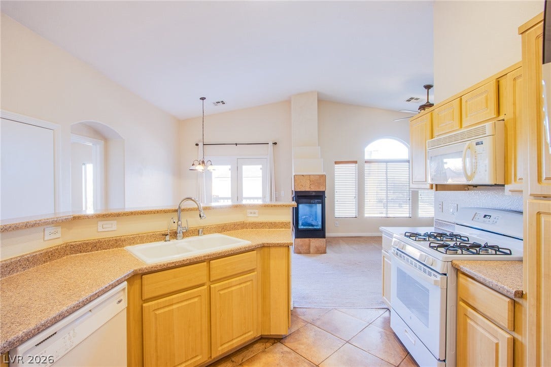 6717 Lookout Lodge Lane, #1, North Las Vegas, NV 89084 An open floorplan seamlessly connects the kitchen to the living area under vaulted ceilings.