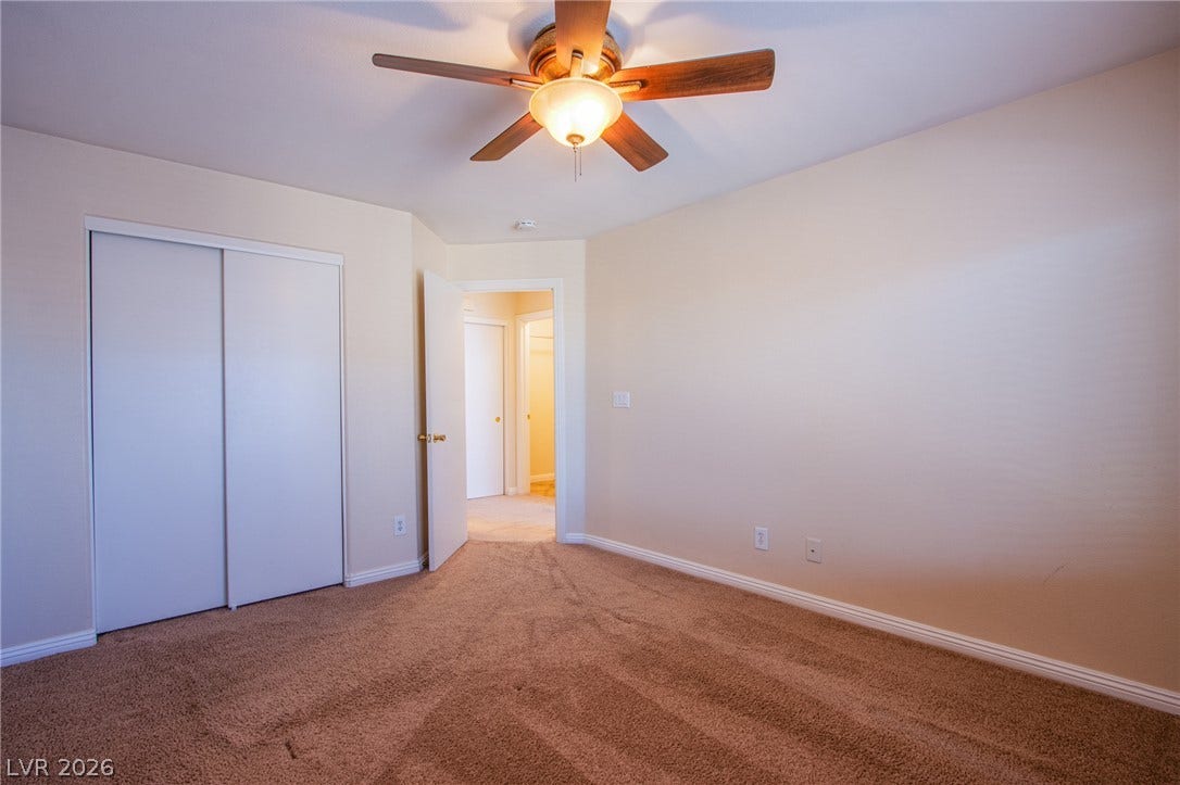 6717 Lookout Lodge Lane, #1, North Las Vegas, NV 89084 Plush wall-to-wall carpeting and clean baseboards define this tranquil bedroom space.