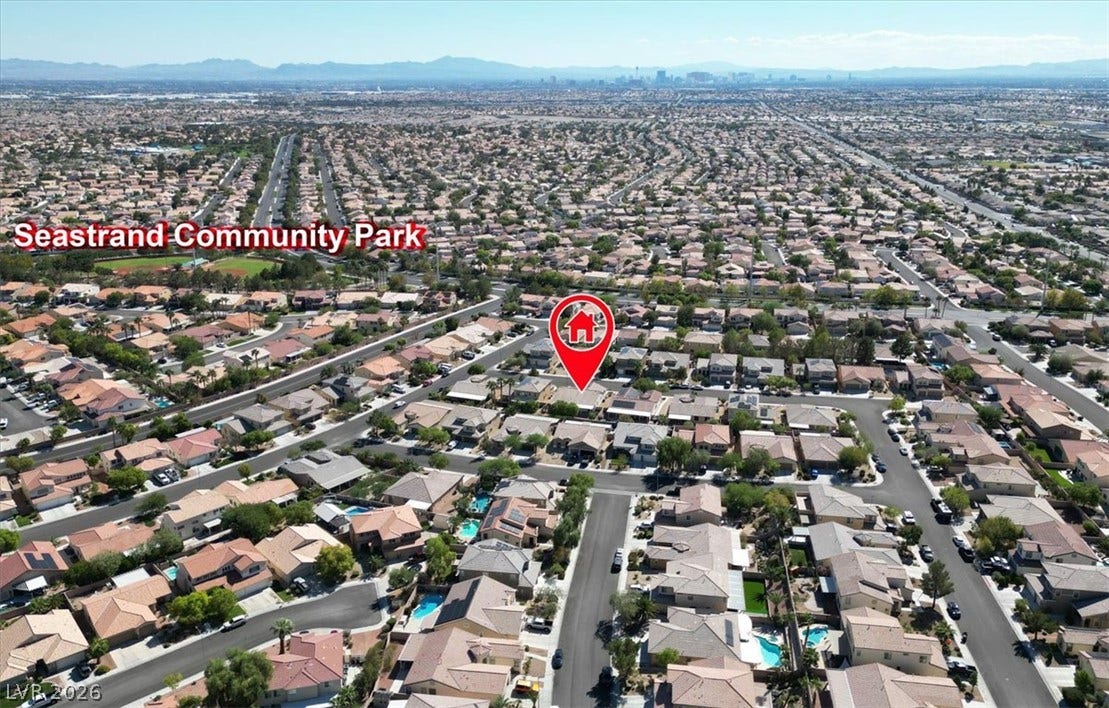 Aerial view highlights the home set within a vibrant residential neighborhood near local parks.