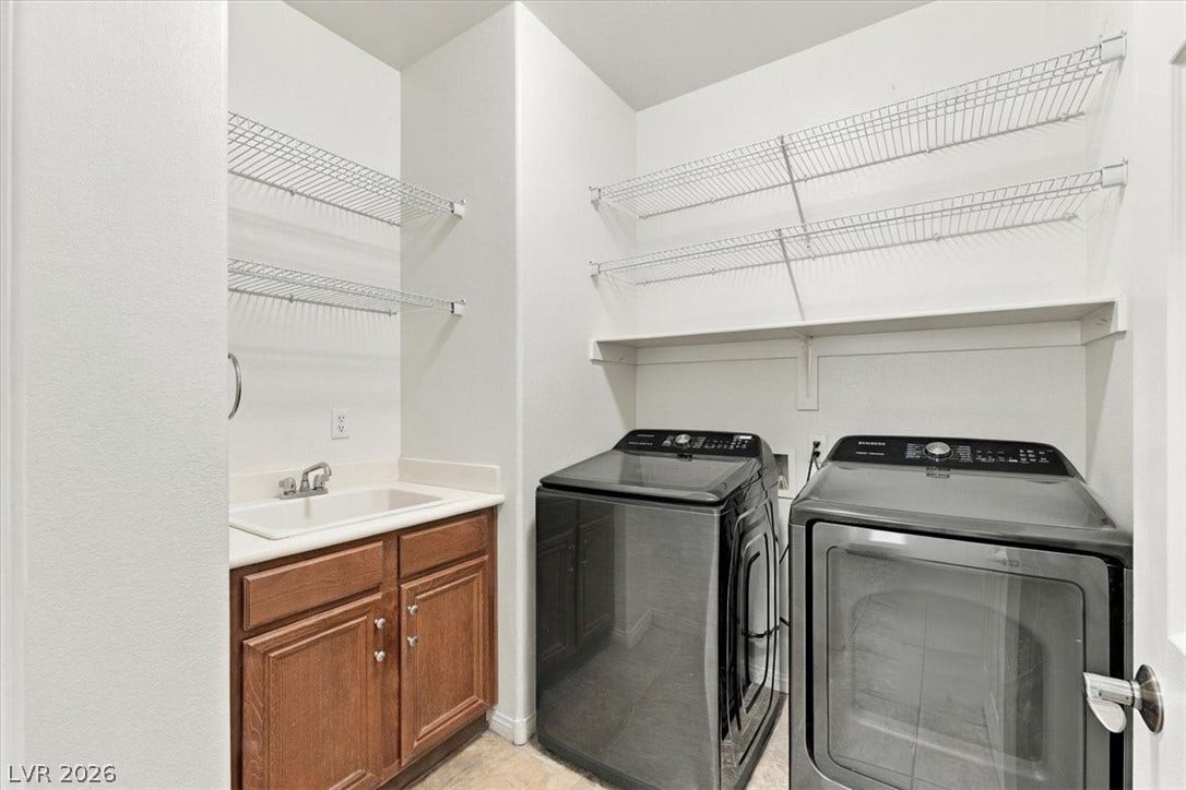 Ample wire shelving and a built-in utility sink maximize function in this dedicated laundry space.