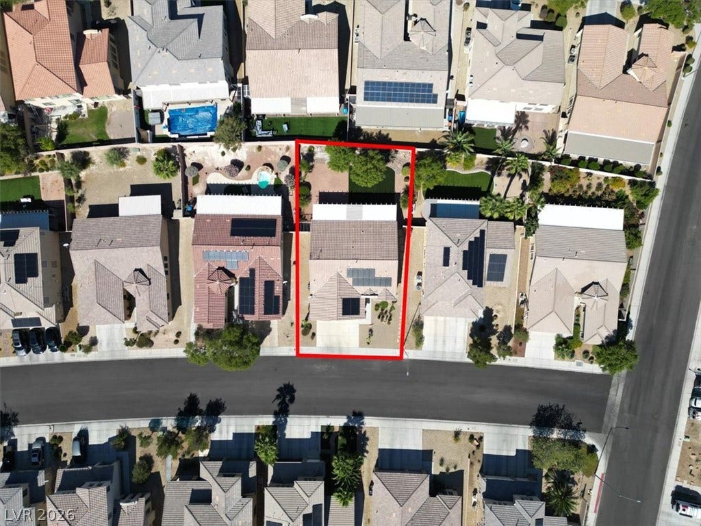 An aerial perspective shows the property footprint highlighted within its established suburban neighborhood.