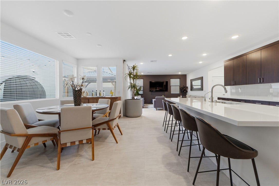 544 Front Range Lane, North Las Vegas, NV 89084 An open floorplan seamlessly connects the casual dining area with the modern kitchen island.