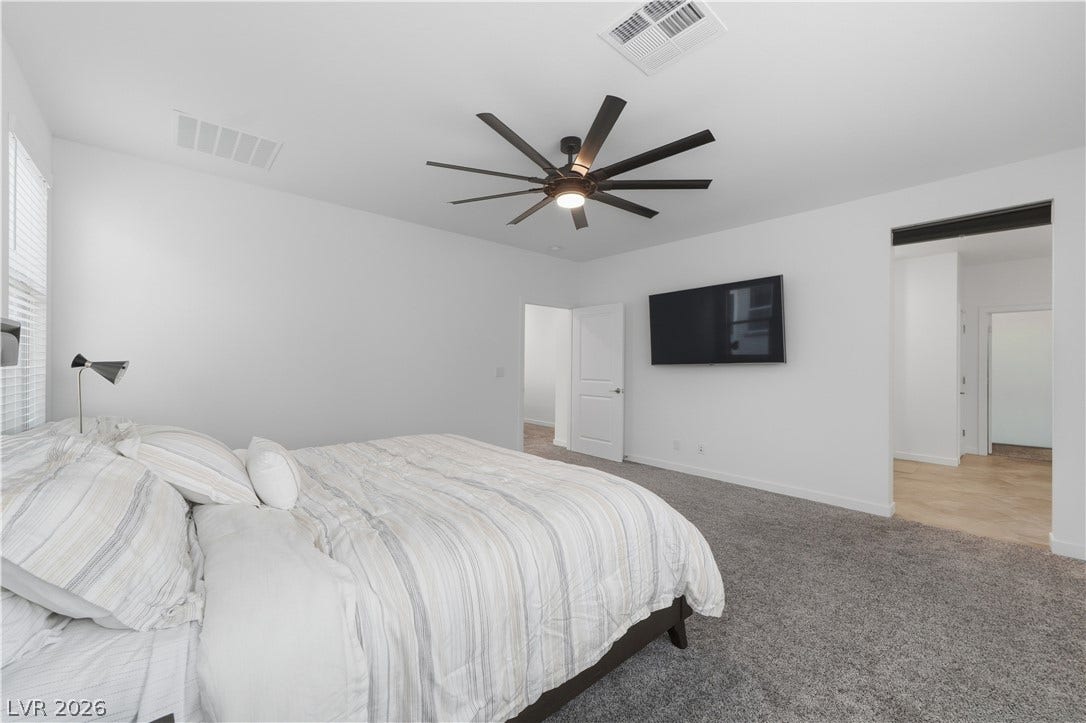 544 Front Range Lane, North Las Vegas, NV 89084 Plush carpeting anchors this comfortable bedroom showcasing clean lines and abundant natural light.