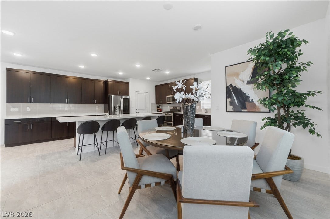 544 Front Range Lane, North Las Vegas, NV 89084 An open-concept layout connects the dining space seamlessly to a modern kitchen with recessed lighting.