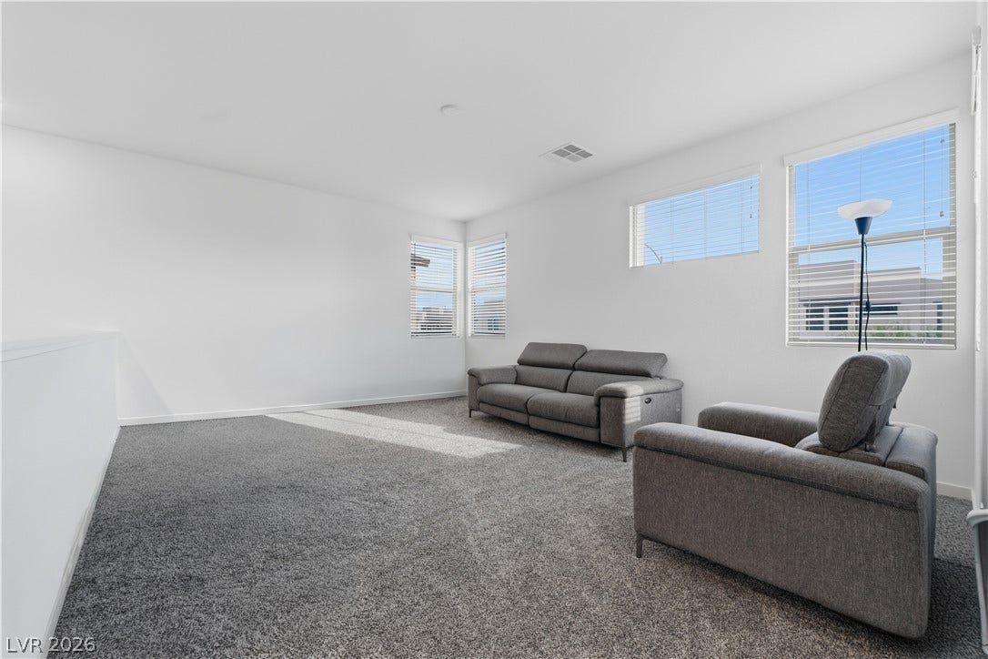 544 Front Range Lane, North Las Vegas, NV 89084 Plentiful natural light streams through multiple windows into this spacious carpeted loft.