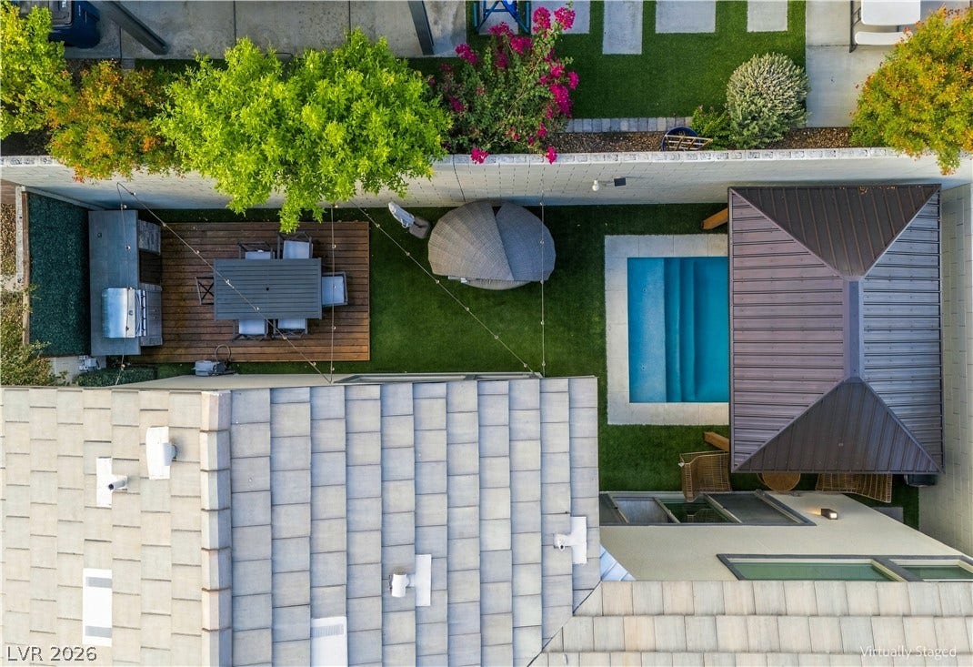 544 Front Range Lane, North Las Vegas, NV 89084 An aerial view highlights the beautifully landscaped backyard with a pool and dining patio.