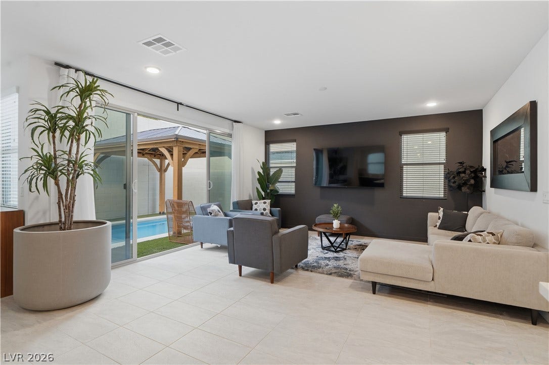 544 Front Range Lane, North Las Vegas, NV 89084 Sliding glass doors connect the spacious main living area to a private pool courtyard.