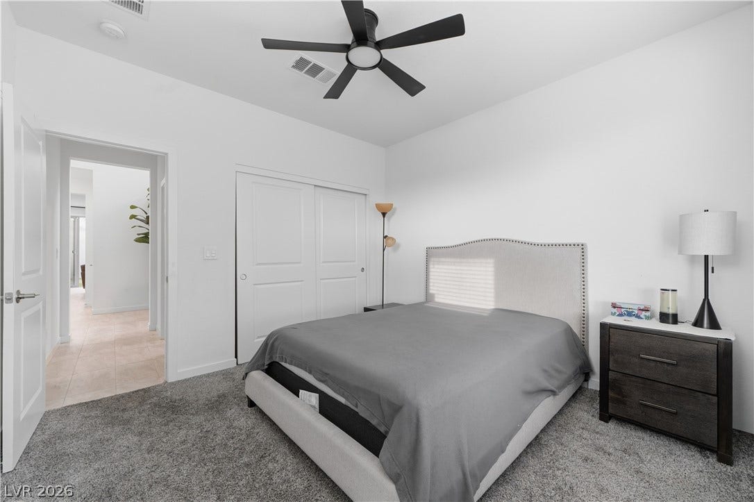 544 Front Range Lane, North Las Vegas, NV 89084 Plush carpet underfoot and clean lines define this serene and minimalist bedroom space.