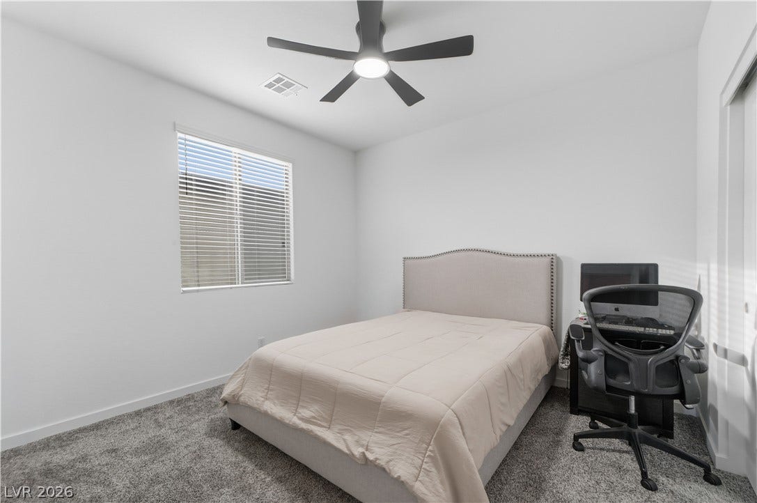 544 Front Range Lane, North Las Vegas, NV 89084 Plush carpeted flooring and a large window define this comfortable, versatile space.