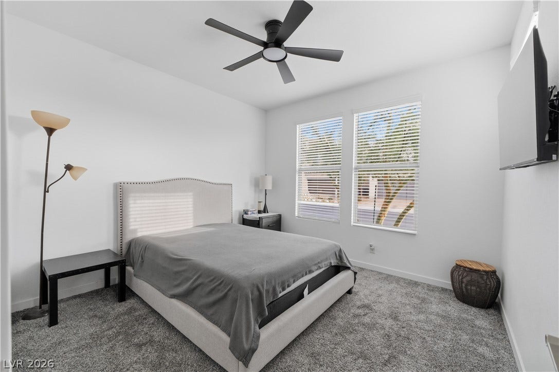 544 Front Range Lane, North Las Vegas, NV 89084 Plentiful natural light streams through multiple windows onto plush carpeted flooring.