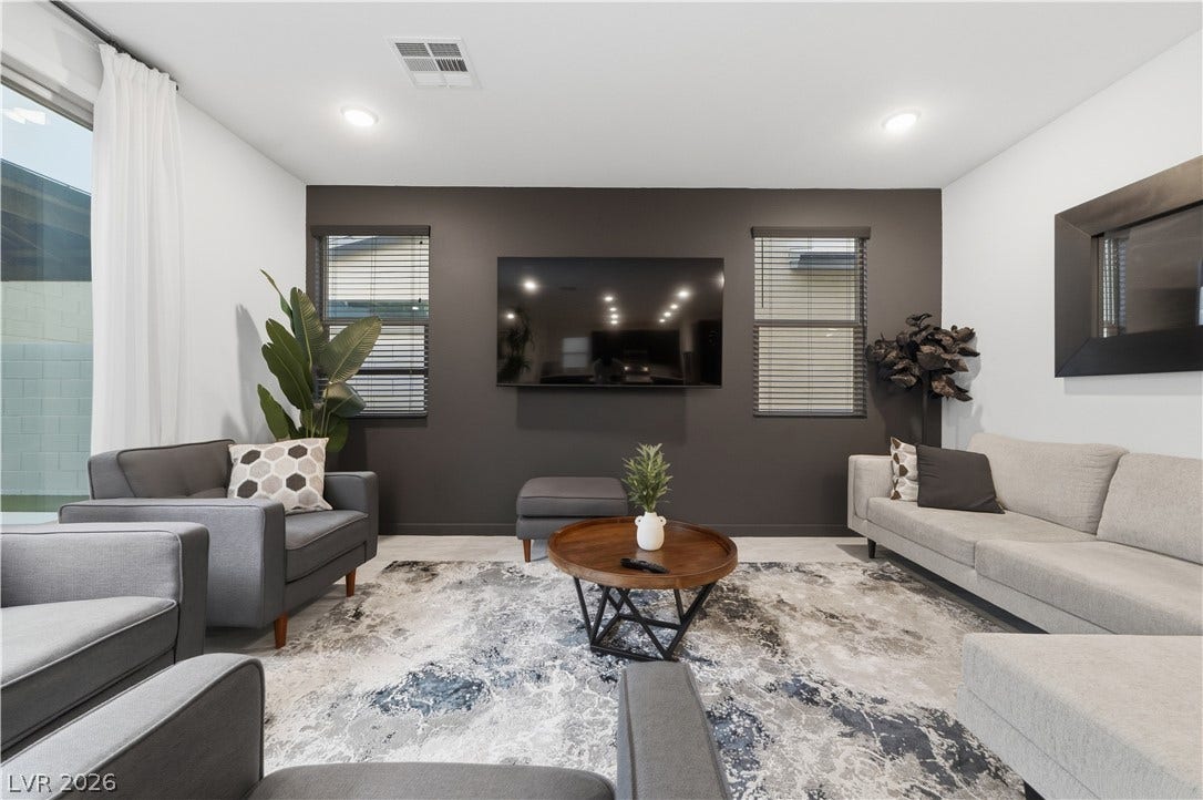 544 Front Range Lane, North Las Vegas, NV 89084 Crisp recessed lighting illuminates a modern living space finished with light hardwood flooring.