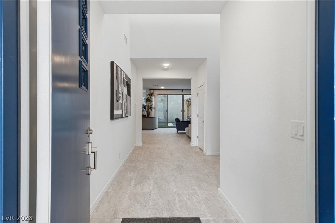 544 Front Range Lane, North Las Vegas, NV 89084 An inviting entrance foyer welcomes guests with towering ceilings and clean, tiled flooring.