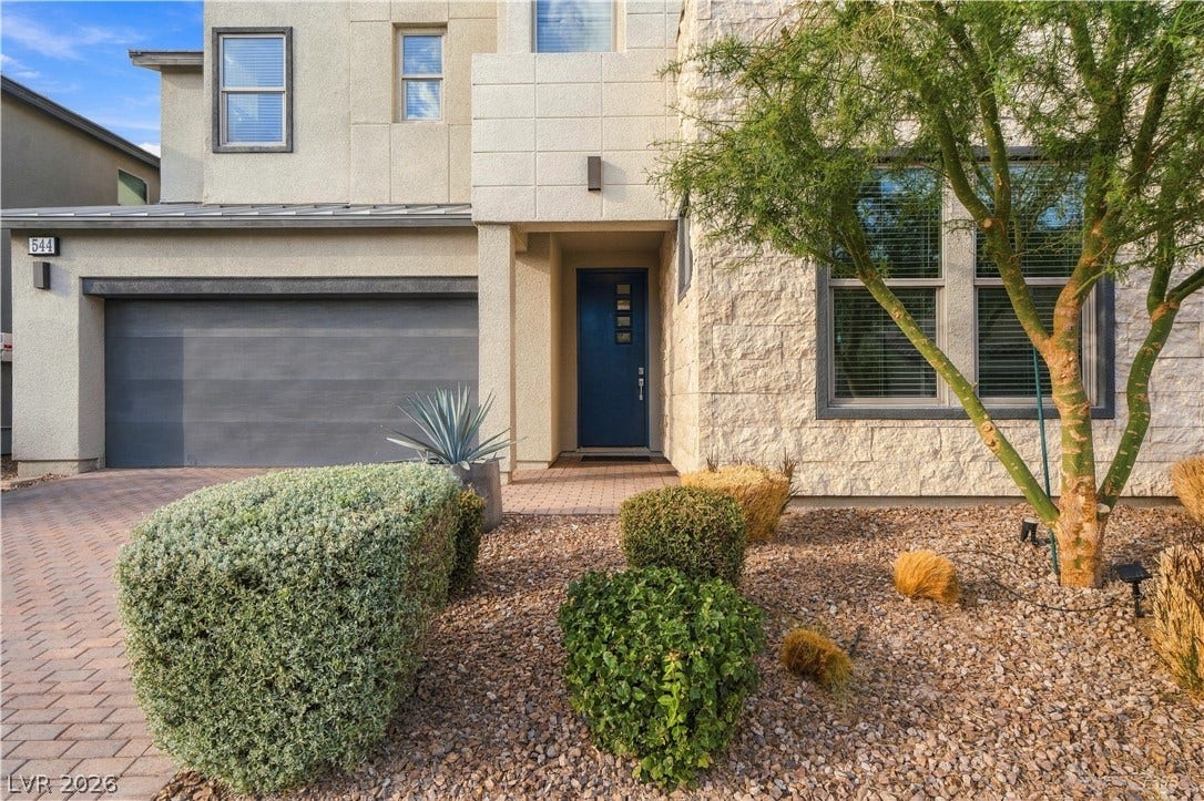 544 Front Range Lane, North Las Vegas, NV 89084 Modern stone and stucco accents define this contemporary multi-level home exterior.