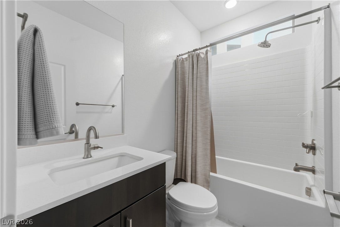 544 Front Range Lane, North Las Vegas, NV 89084 An undermount sink vanity pairs seamlessly with a classic tub shower combo.