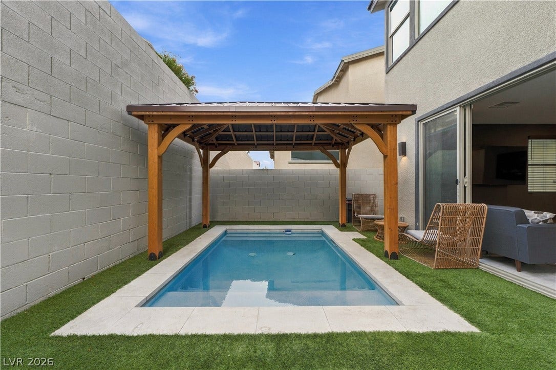 544 Front Range Lane, North Las Vegas, NV 89084 An inviting plunge pool sits framed by artificial turf and a handsome wooden gazebo.