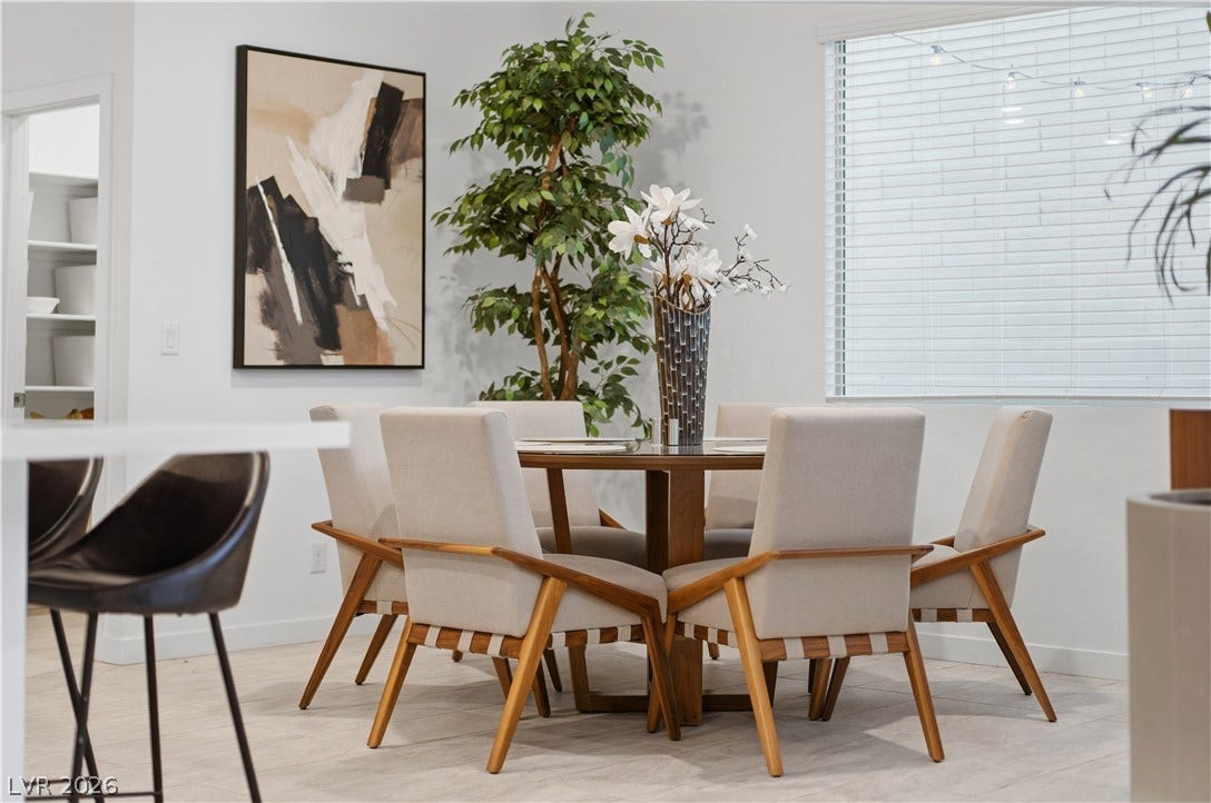 544 Front Range Lane, North Las Vegas, NV 89084 An open dining area showcases sleek tile flooring and a large window inviting natural light.