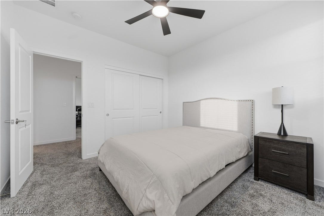 544 Front Range Lane, North Las Vegas, NV 89084 Plush carpeting and clean white walls create a quiet retreat in this comfortable bedroom.