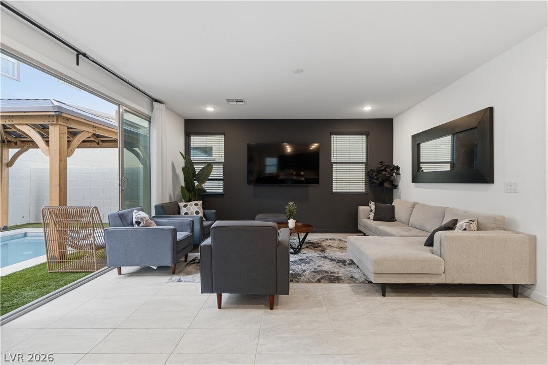 544 Front Range Lane, North Las Vegas, NV 89084 Sliding glass doors merge this modern living space with the poolside terrace.