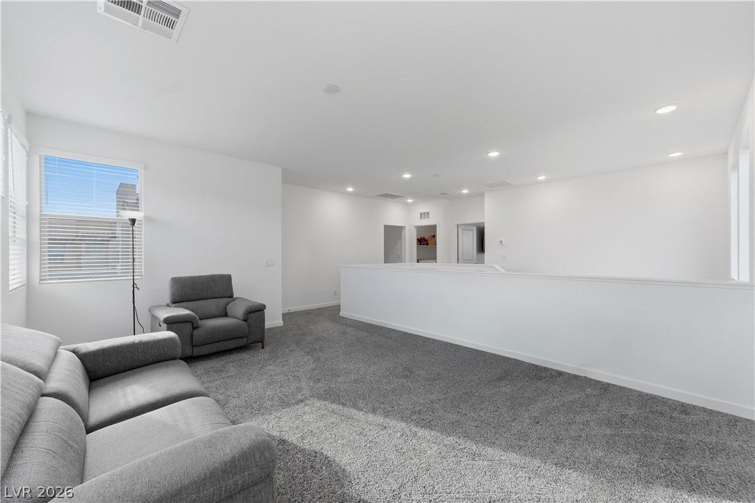 544 Front Range Lane, North Las Vegas, NV 89084 A spacious upper-level loft features wall-to-wall carpeting and recessed lighting.