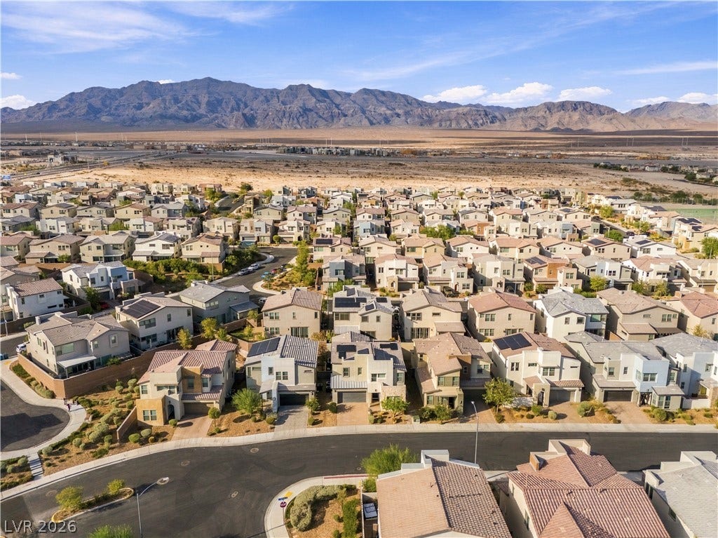 544 Front Range Lane, North Las Vegas, NV 89084 Sweeping mountain vistas frame the neighborhood, highlighting the modern architectural designs of the residential community.