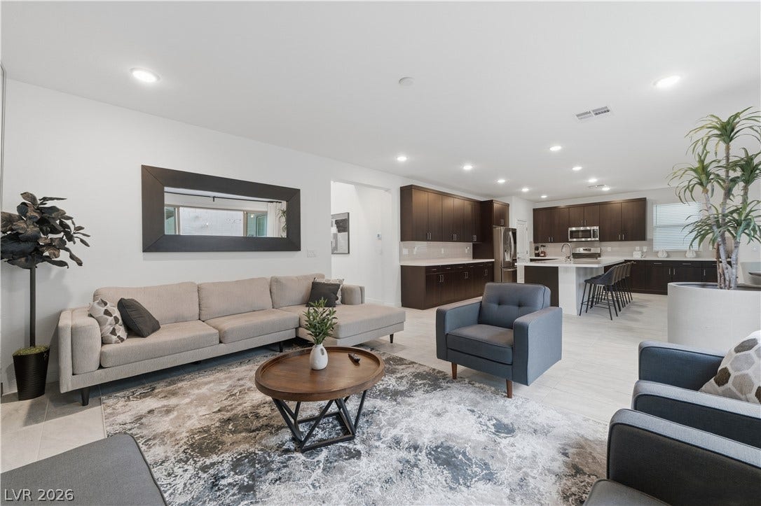 544 Front Range Lane, North Las Vegas, NV 89084 An open floor plan seamlessly connects the comfortable living space to a modern kitchen.