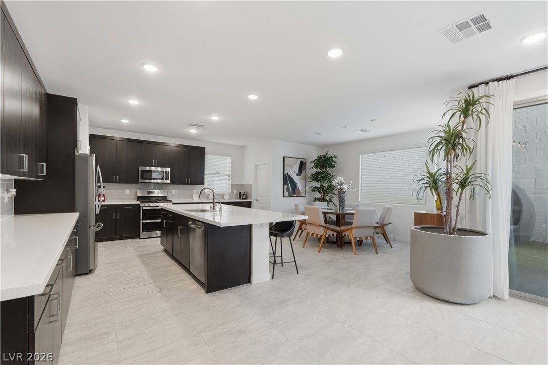 544 Front Range Lane, North Las Vegas, NV 89084 An open layout connects the modern kitchen and dining space under recessed lighting.