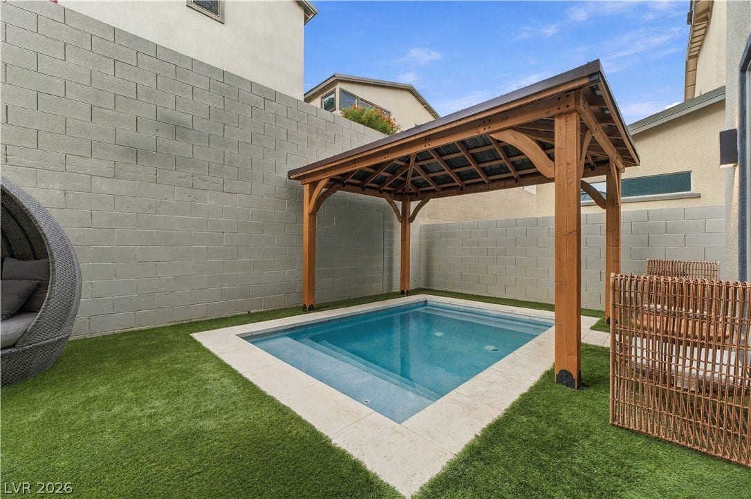 544 Front Range Lane, North Las Vegas, NV 89084 An inviting plunge pool sits framed by artificial turf and a handsome wooden gazebo.
