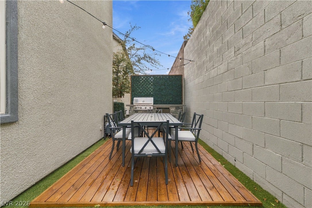 544 Front Range Lane, North Las Vegas, NV 89084 An intimate wood deck patio provides a private outdoor retreat bordered by high walls.