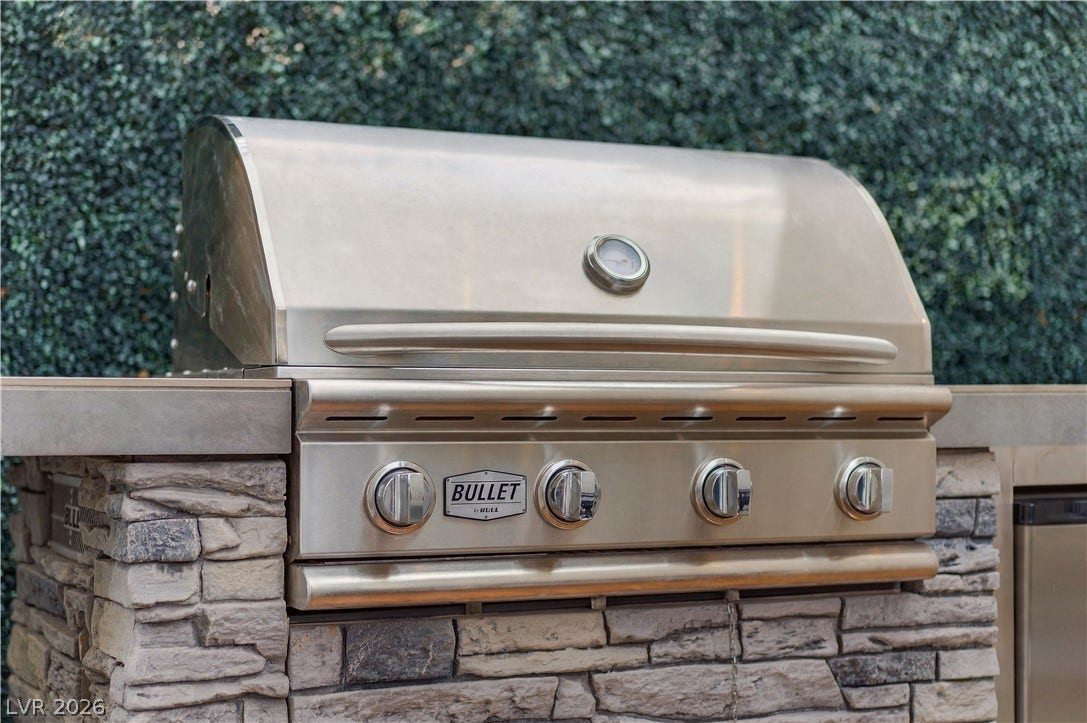 544 Front Range Lane, North Las Vegas, NV 89084 An outdoor cooking area features a premium built-in grill integrated into a stone island.