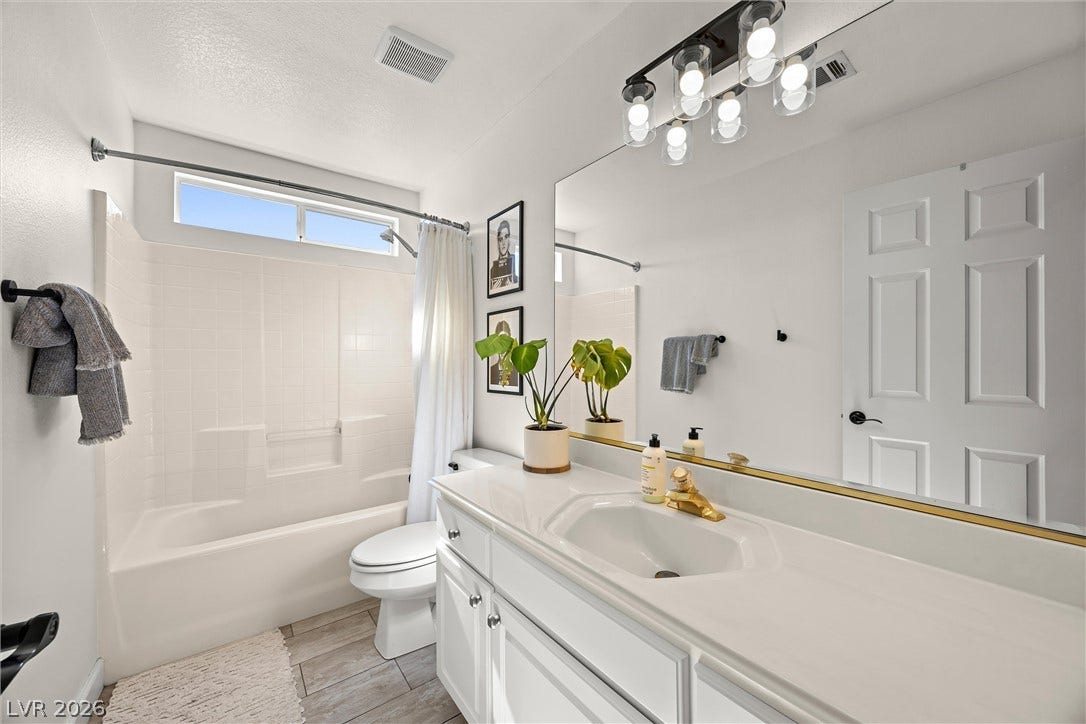 1421 Dragon Rock Drive, Henderson, NV 89052 Clean lines and a spacious vanity define this modern bathroom space.