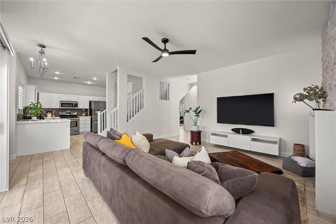 1421 Dragon Rock Drive, Henderson, NV 89052 Gleaming tile floors run throughout this airy living room connected to an open kitchen.