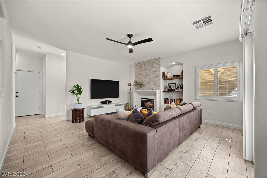 1421 Dragon Rock Drive, Henderson, NV 89052 An inviting stone fireplace serves as the centerpiece of this spacious open living area.