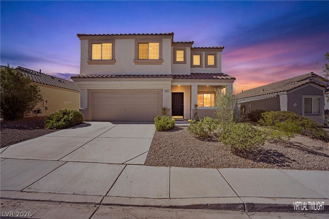 1421 Dragon Rock Drive, Henderson, NV 89052 Spanish tile roofing and low-maintenance desert landscaping define this modern two-story home.