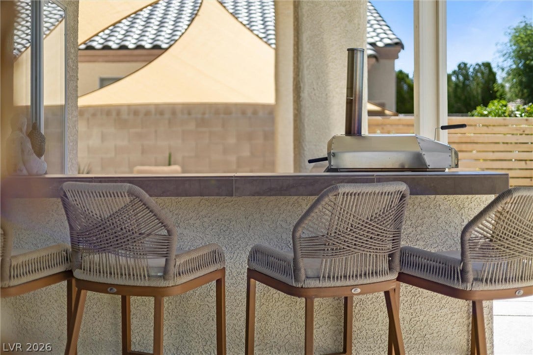 1421 Dragon Rock Drive, Henderson, NV 89052 Tiled counter spaces and covered shelter elevate this backyard cooking station.