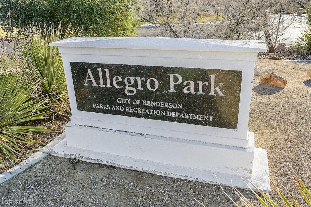 1421 Dragon Rock Drive, Henderson, NV 89052 A stone monument sign marks the entrance to Allegro Park in a desert landscape.