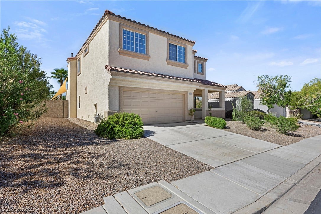1421 Dragon Rock Drive, Henderson, NV 89052 Spanish tile roofing and stucco exterior walls create classic curb appeal for this two-story home.