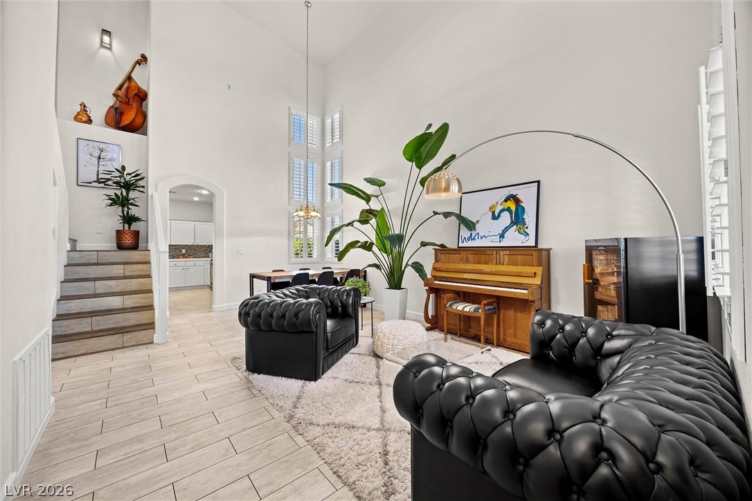 1421 Dragon Rock Drive, Henderson, NV 89052 Vaulted ceilings and wood-look tile floors define this airy, open living room.