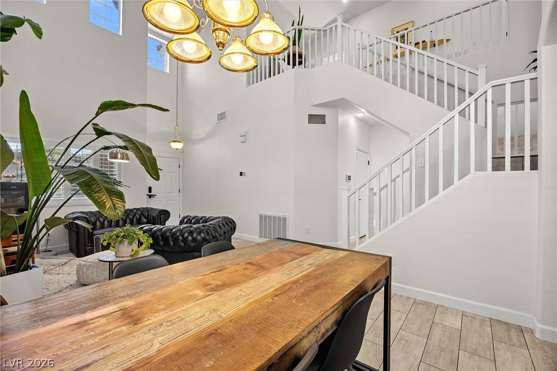 1421 Dragon Rock Drive, Henderson, NV 89052 A spacious dining area sits adjacent to soaring ceilings and a winding staircase.