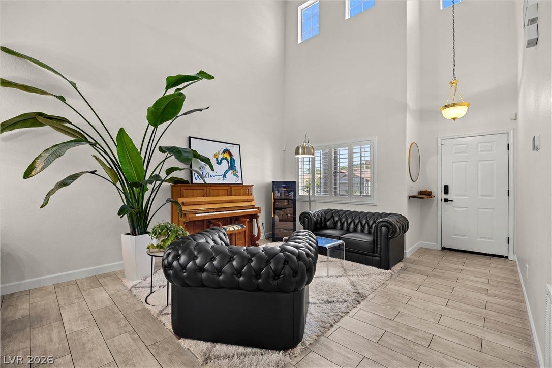 1421 Dragon Rock Drive, Henderson, NV 89052 Dramatic high ceilings and wood-look tile floors define this airy welcoming space.