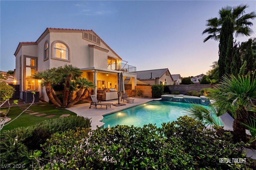 1421 Dragon Rock Drive, Henderson, NV 89052 A sparkling swimming pool serves as the centerpiece of this desert-landscaped backyard retreat.